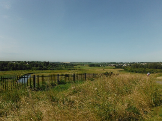 View of the Sturgeon River valley, and a glimpse of the river, from the top of a rise.